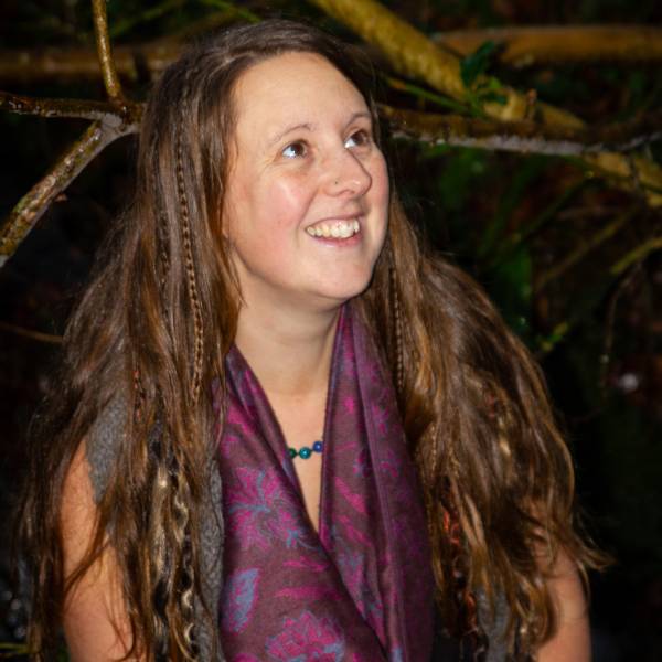 Holistic healer smiling looking upward.